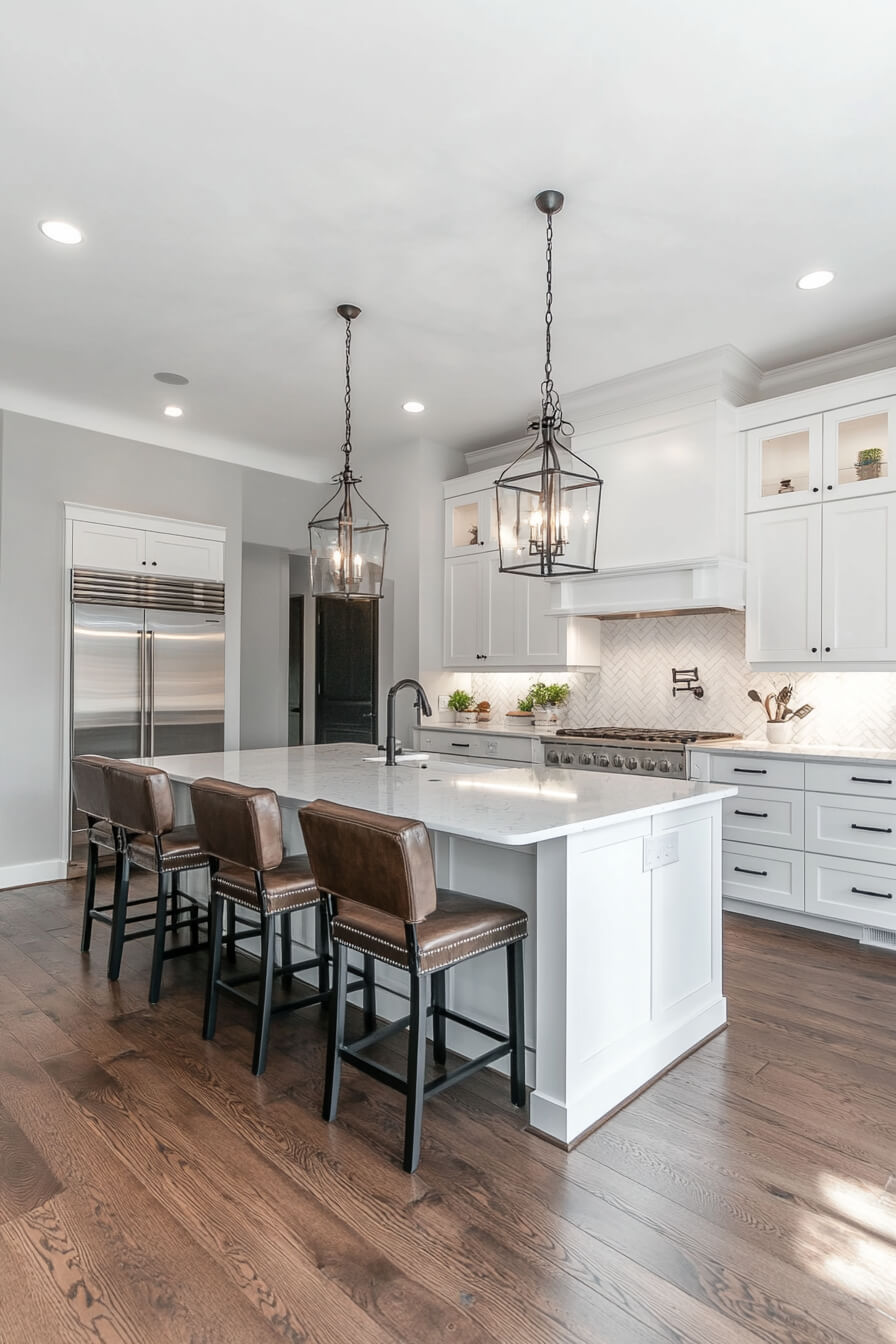 A modern white kitchen with a marble island, stylish pendant lighting, and dark wood floors, complemented by sleek cabinetry, modern appliances, and vibrant greenery, showcasing a sophisticated Kitchen Design White and a functional Kitchen Room Design.